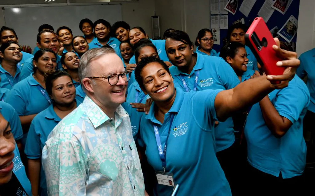 Australian Prime Minister Anthony Albanese (L) poses for a selfie with staff and students during a tour of the Australia Pacific Training Coalition centre (APTC) after attending the Pacific Islands Forum (PIF), in Suva on July 15, 2022. (William West/AFP via Getty Images)