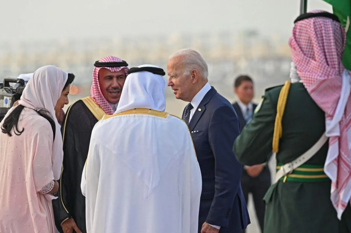 President Joe Biden is welcomed by Mecca province governor Prince Khaled al-Faisal (white robe) and Princess Reema bint Bandar Al-Saud (L), Saudi Arabia's ambassador to Washington, at the King Abdulaziz International Airport in the Saudi coastal city of Jeddah, upon his arrival from Israel, on July 15, 2022. (Mandel Ngan/AFP via Getty Images)