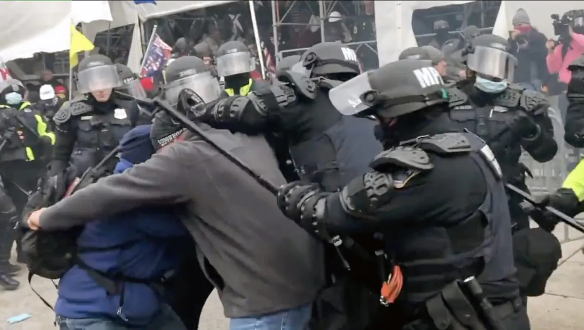 Police attack two protesters on the west side of the Capitol on Jan. 6, 2021, in this scene from the EpochTV documentary, "The Real Story of Jan. 6." (Steve Baker/EpochTV)