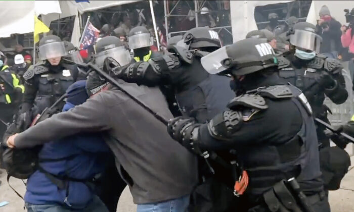 Police attack two protesters on the west side of the Capitol on Jan. 6, 2021, in this scene from the EpochTV documentary, "The Real Story of Jan. 6." (Steve Baker/EpochTV)