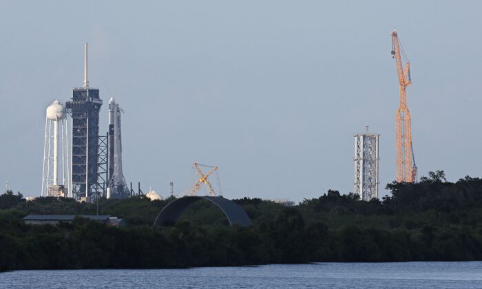 A SpaceX Falcon 9 rocket sits at launch pad LC-39A (L) as refurbishments are made to one of their facilities at the Kennedy Space Center in Fla., on July 14, 2022. (Gregg Newton/AFP via Getty Images)
