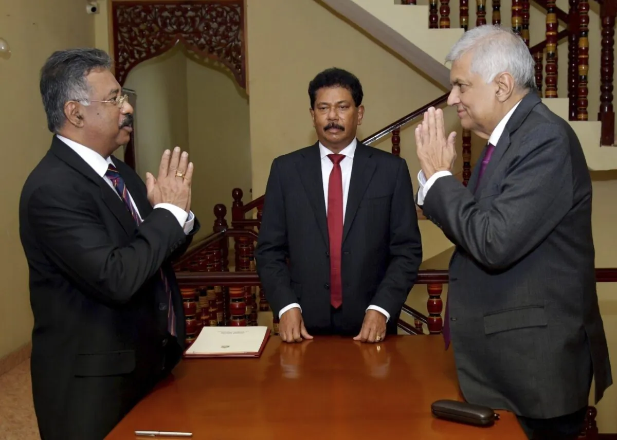 Sri Lankan interim president Ranil Wickremesinghe (R) greets Chief Justice Jayantha Jayasuriya during the oath-taking ceremony in Colombo, Sri Lanka, on July 15, 2022. (Sri Lankan President's Office via AP)