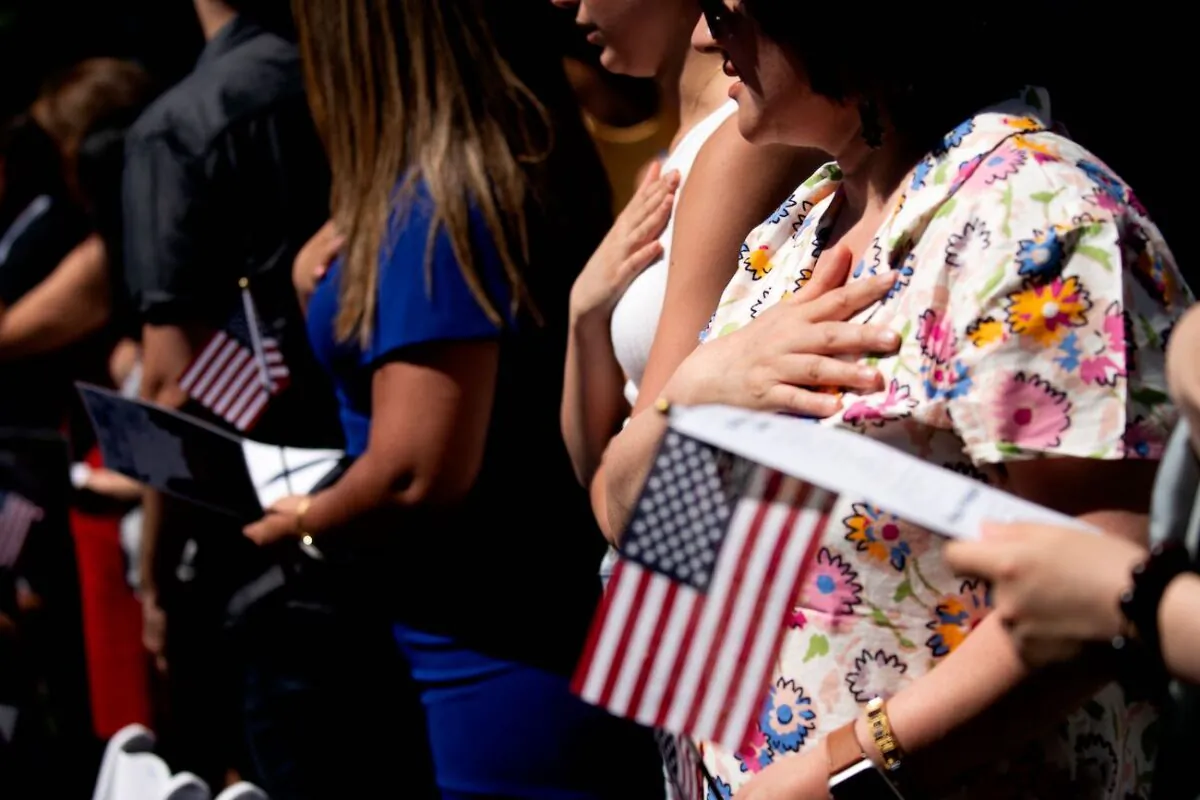New US citizens recite the Pledge of Allegiance during their naturalization ceremony at George Washington's residence in Mount Vernon, Va., on July 4, 2022. (Stefani Reynolds/AFP via Getty Images)