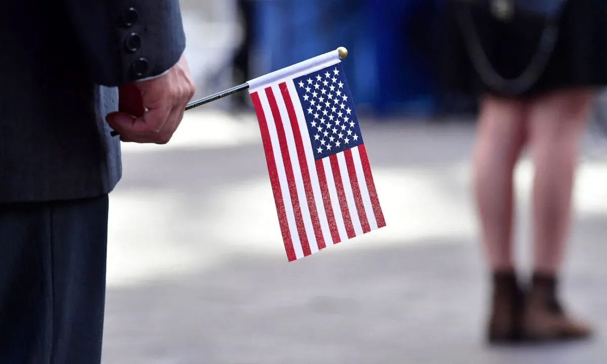People hold U.S. flags while attending their Naturalization Oath ceremony for U.S. citizenship in Los Angeles, Calif., on May 25, 2022. (Frederic J. Brown/AFP via Getty Images)