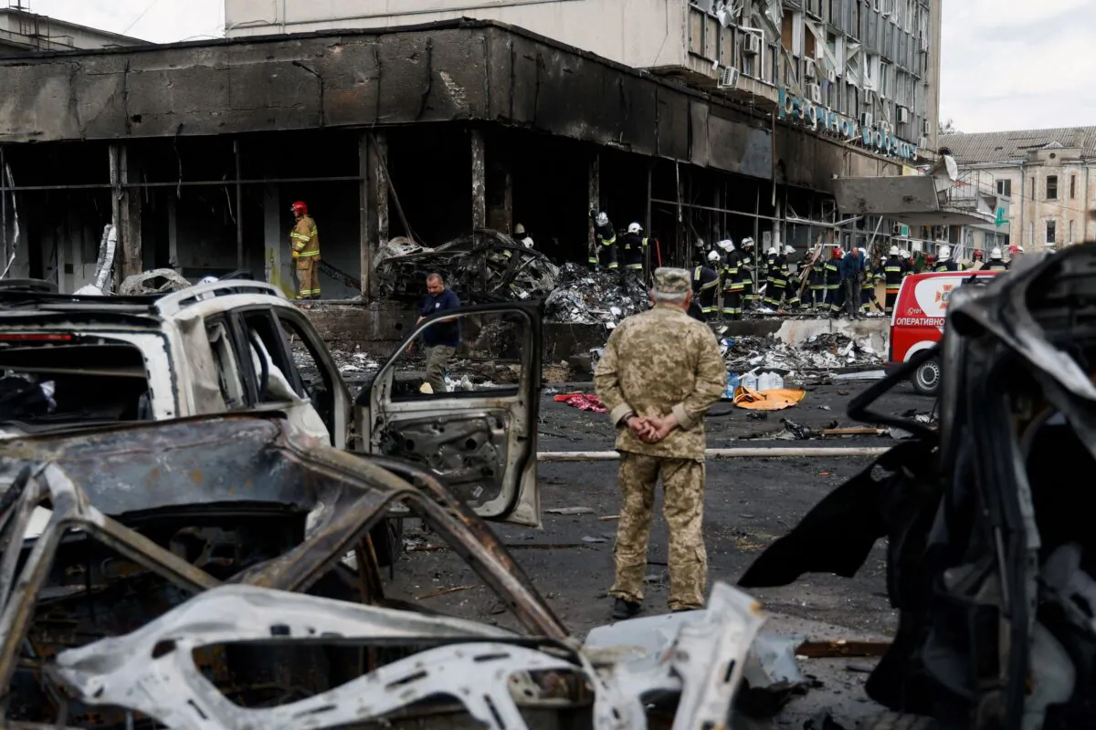 Emergency services work next to a damaged building at the site of a Russian military strike in Vinnytsia, Ukraine, on July 14, 2022. (Valentyn Ogirenko/Reuters)