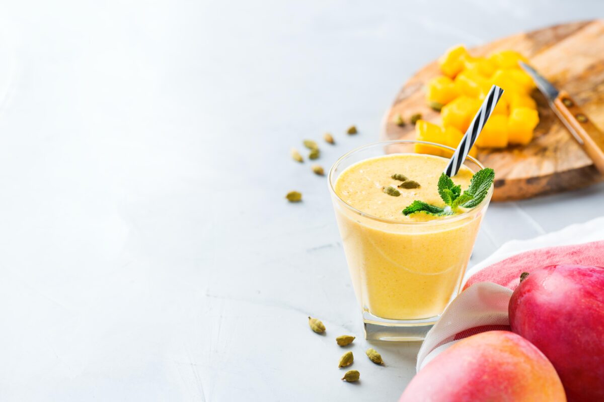 Mango lassi blends sweet mangos with plain yogurt, sugar, milk and ice. 
 (Aamulya/iStock / Getty Images Plus)