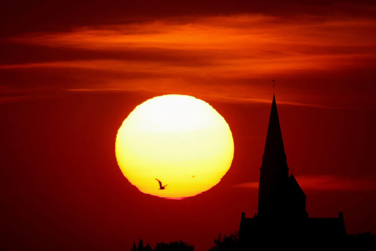 A church is pictured during sunset as a heat wave hits Europe, in Oisy-le-Verger, France, on July 14, 2022. (Pascal Rossignol/Reuters)