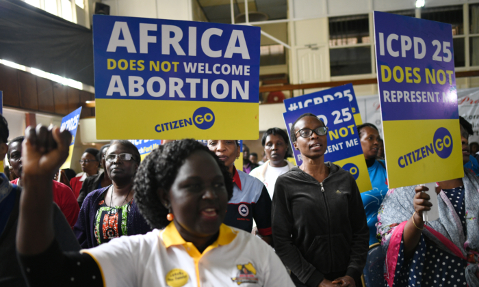File photo: Anti-abortion, and pro family activists hold placards during a prayer rally to protest against an abortion agenda in Nairobi, on  November 14, 2019. (Simon Maina/AFP via Getty Images)