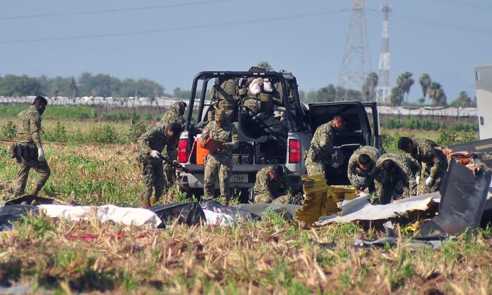 Mexican Army soldiers are working on July 15, 2022, at the scene of a Navy helicopter crash near Los Mochis Airport, Sinaloa, Mexico.  (JoseMendoza / AFP via Getty Images)
