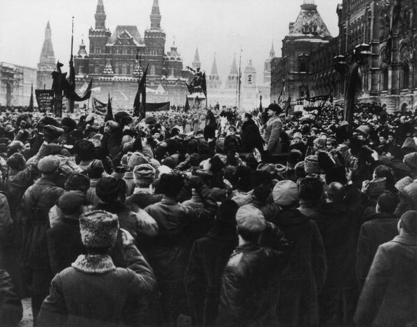 View of a large crowd assembled in Red Square, with Bolshevik leaders Joseph Stalin (right) and Leon Trotsky standing on a podium, during the Russian Revolution in Moscow, Russia. (Hulton Archive/Getty Images)