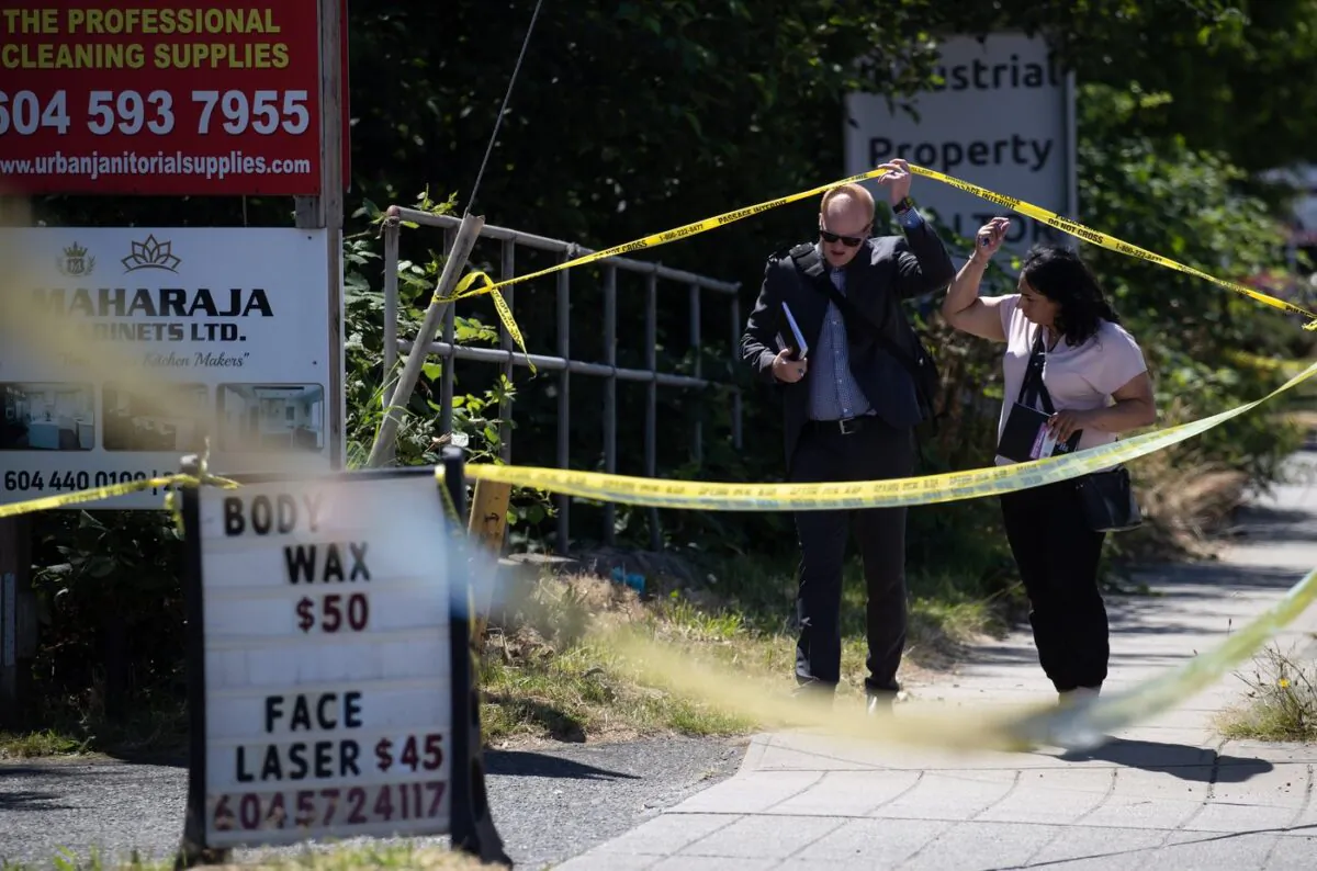 Investigators arrive at the scene of a fatal shooting, in Surrey, B.C., on July 14, 2022. (The Canadian Press/Darryl Dyck)