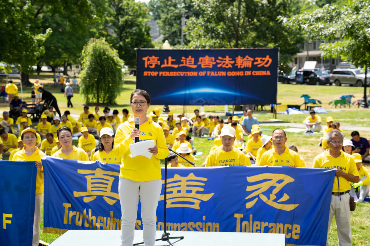 Yuhua Zhang speaks about her experience being tortured while detained in China because of her faith in Falun Gong, at a rally in Goshen, N.Y., on July 17, 2022. Falun Gong adherents have been persecuted in China for nearly 23 years. (Larry Dye/The Epoch Times)