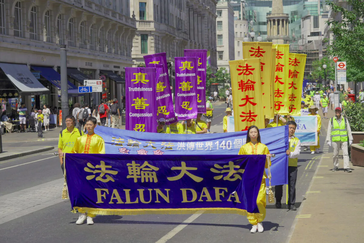Falun Gong practitioners march to highlight the 23rd year of persecution in China against the spiritual discipline, in London on July 16, 2022. (Yanning Qi/The Epoch Times)