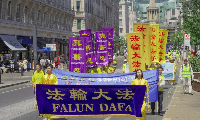 Falun Gong practitioners march to highlight the 23rd year of persecution in China against the spiritual discipline, in London on July 16, 2022. (Yanning Qi/The Epoch Times)
