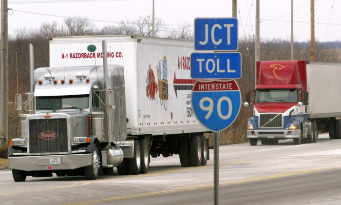 Tractor-trailers move along an interstate frontage road in Hampshire, Ill., on Jan. 13, 2004. (Tim Boyle/Getty Images)