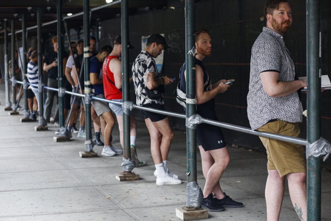People wait in line to receive the monkeypox vaccine before the opening of a new mass vaccination site at the Bushwick Education Campus in Brooklyn, New York, on July 17, 2022. (Kena Betancur/AFP via Getty Images)