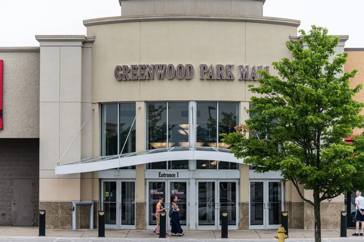 A group of people wait outside of an entrance to Greenwood Park Mall in Greenwood, Ind., on July 18, 2022. (Jon Cherry/Getty Images)
