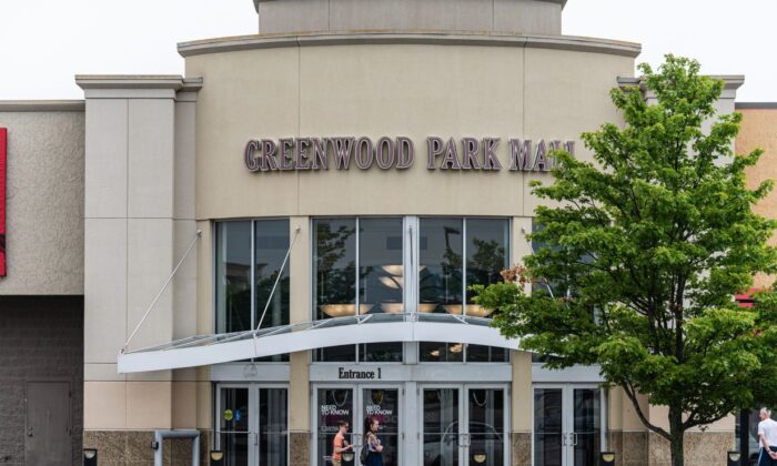 A group of people wait outside of an entrance to Greenwood Park Mall in Greenwood, Ind., on July 18, 2022.  (Jon Cherry/Getty Images)