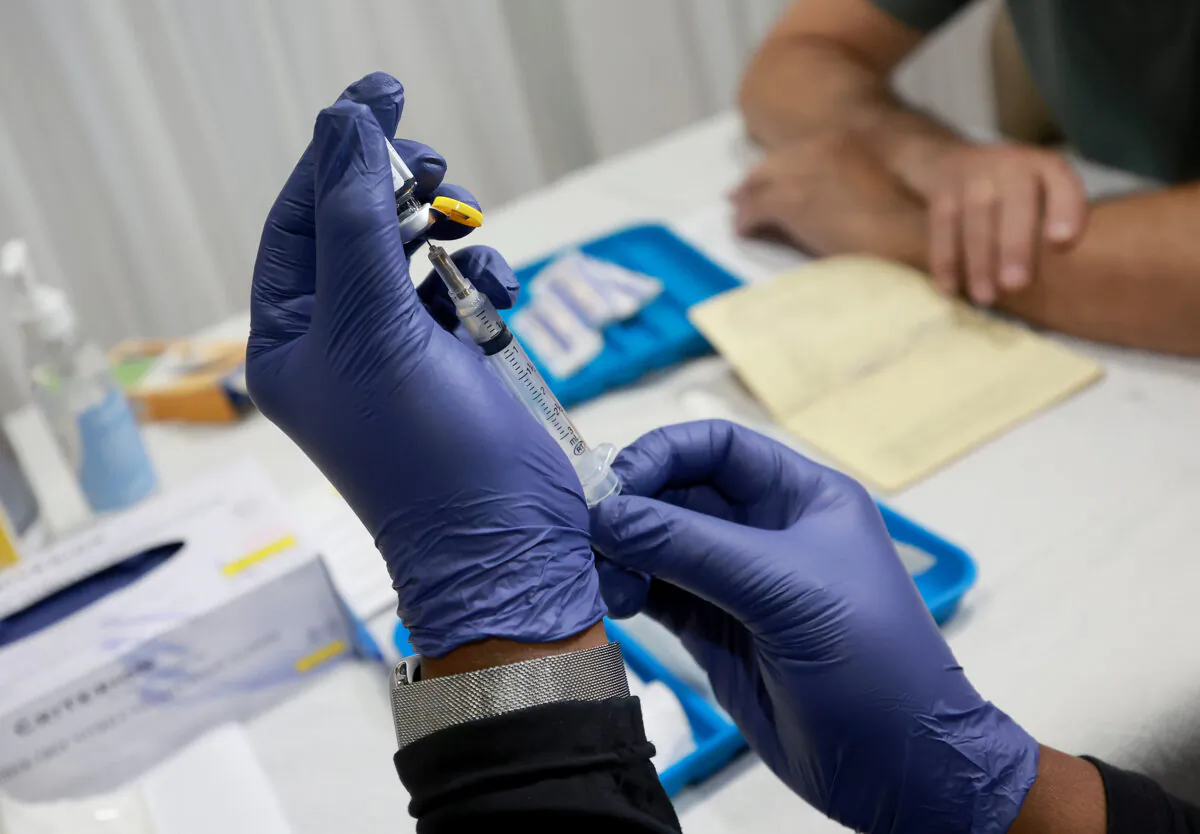 A health care worker prepares to administer a vaccine to a person for the prevention of monkeypox in the Pride Center in Wilton Manors, Florida, on July 12, 2022. (Joe Raedle/Getty Images)