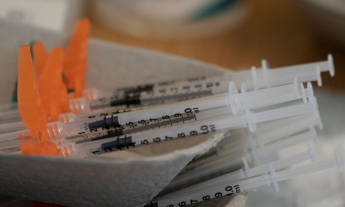 Needles are seen filled with COVID-19 vaccination at a truck stop along highway 91 North in Delta, B.C., on June 16, 2021. (The Canadian Press/Jonathan Hayward)