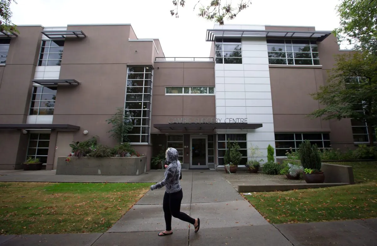 A woman walks past the Cambie Surgery Centre in Vancouver, in a file photo. (The Canadian Press/Darryl Dyck)