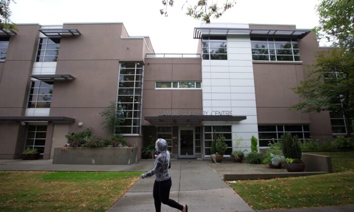 A woman walks past the Cambie Surgery Centre in Vancouver, in a file photo. (The Canadian Press/Darryl Dyck)