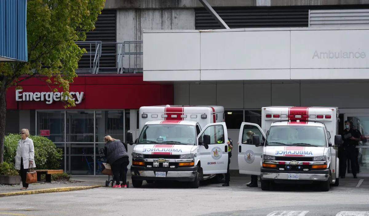 Paramedics and ambulances are seen outside the emergency department at Burnaby Hospital in Burnaby, B.C., May 30, 2022. (The Canadian Press/Darryl Dyck)