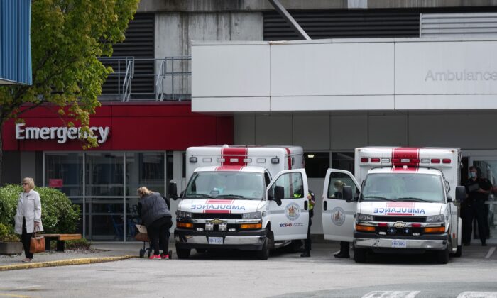 Paramedics and ambulances are seen outside the emergency department at Burnaby Hospital in Burnaby, B.C., May 30, 2022. (The Canadian Press/Darryl Dyck)