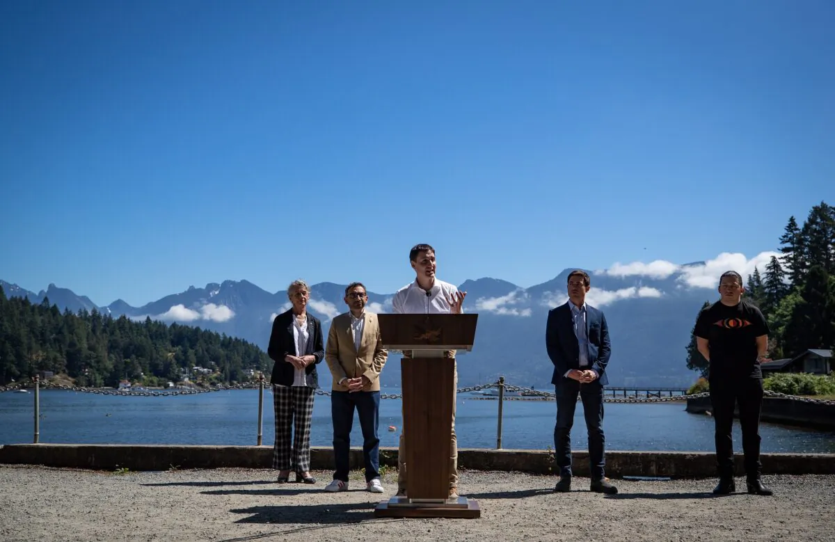 Prime Minister Justin Trudeau speaks during a news conference as (L–R) MP Joyce Murray, Minister of Transport Omar Alghabra, MP Patrick Weiler, and Squamish Nation councillor Khelsilem listen, on Bowen Island, B.C., on July 19, 2022. (Darryl Dyck/The Canadian Press)