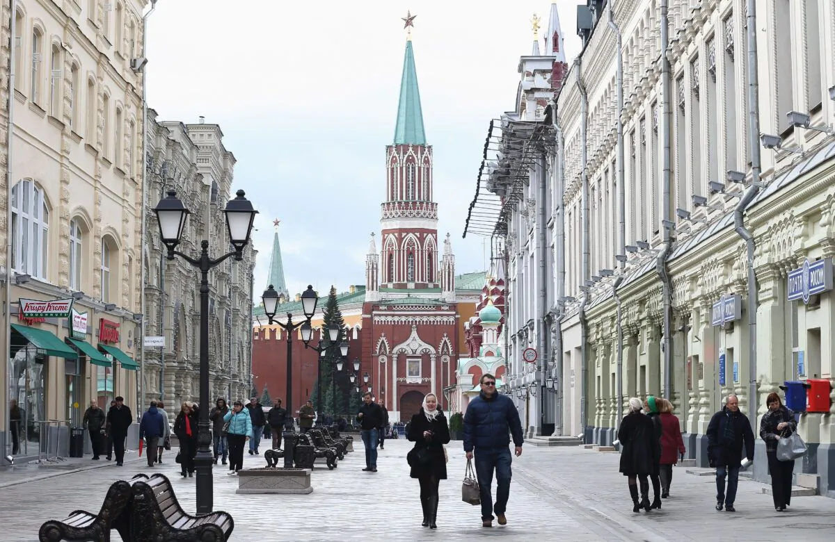 People walk along a shopping street near the gates of the Kremlin in Moscow, in a file photo. We are now experiencing the Russian concept of vranyo, in which everyone knows a lie is being told, and knows that the liar knows that they know. (Andreas Rentz/Getty Images)