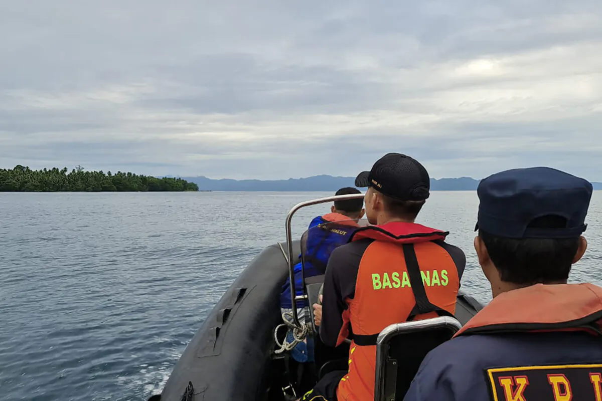 Rescuers on a rubber boat scans the horizon as they search survivors after a passenger boat KM Cahaya Arafah sank in the waters off South Halmahera district in North Maluku, Indonesia, on July 19, 2022. (BASARNAS via AP)
