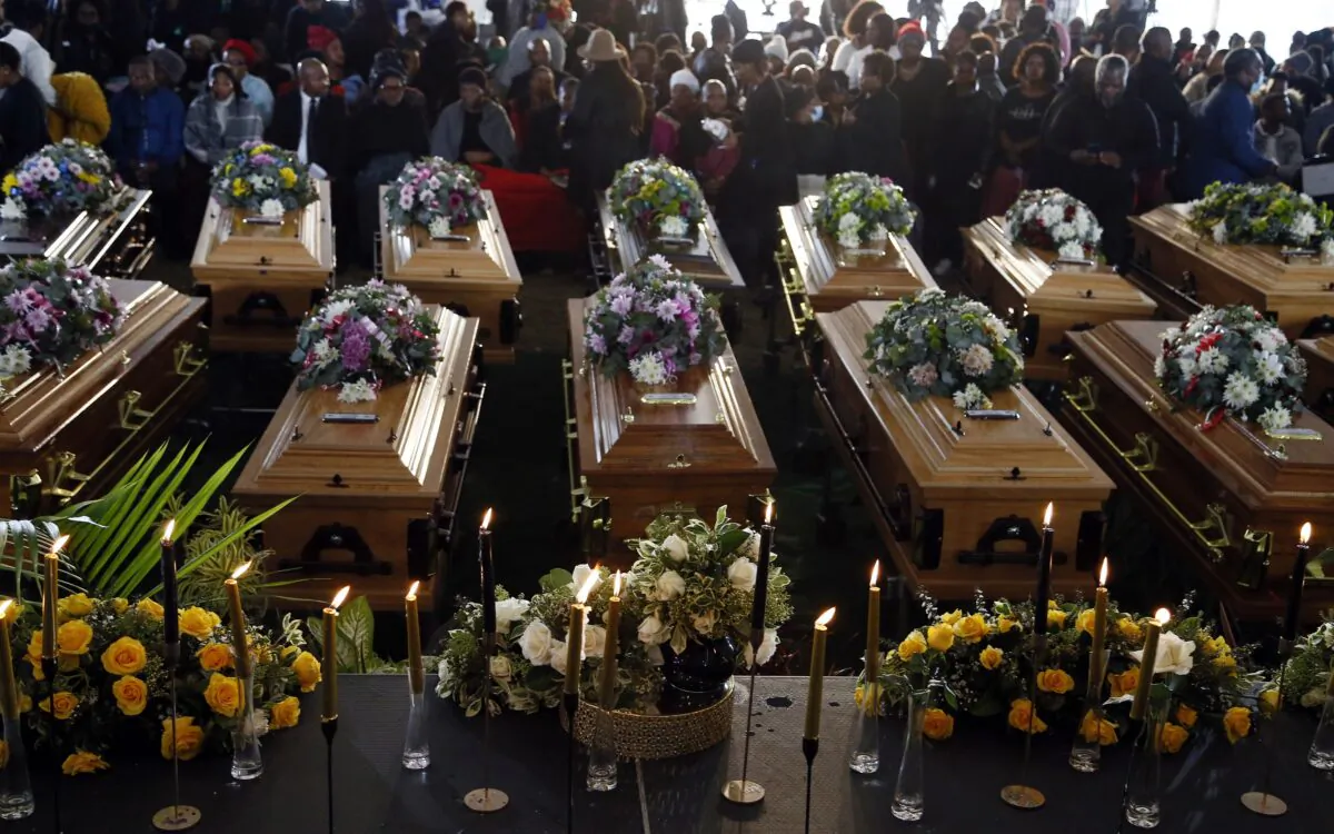 Coffins of 21 teenagers who died in a mysterious tragedy at a nightclub in the early hours of June 26, 2022 are lined up during their funeral held in Scenery Park, East London, South Africa, on July 6, 2022. (AP Photo)