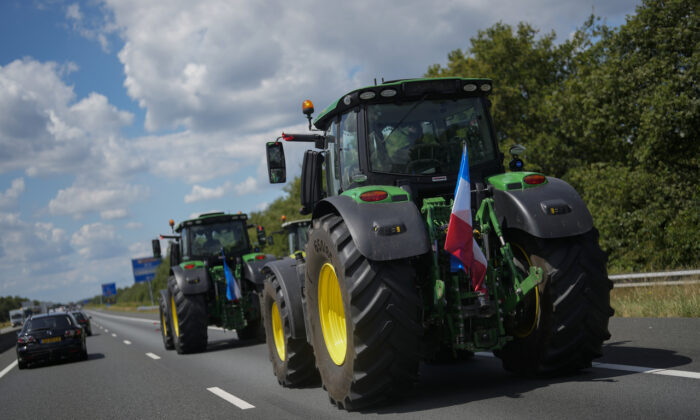 Demonstrating farmers slow down traffic on a motorway near Venlo, southern Netherlands, on July 4, 2022. Dutch farmers angry at government plans to slash emissions used tractors and trucks to blockade supermarket distribution centers, the latest actions in a summer of discontent in the country's lucrative agricultural sector. (Thibault Camus/AP Photo)