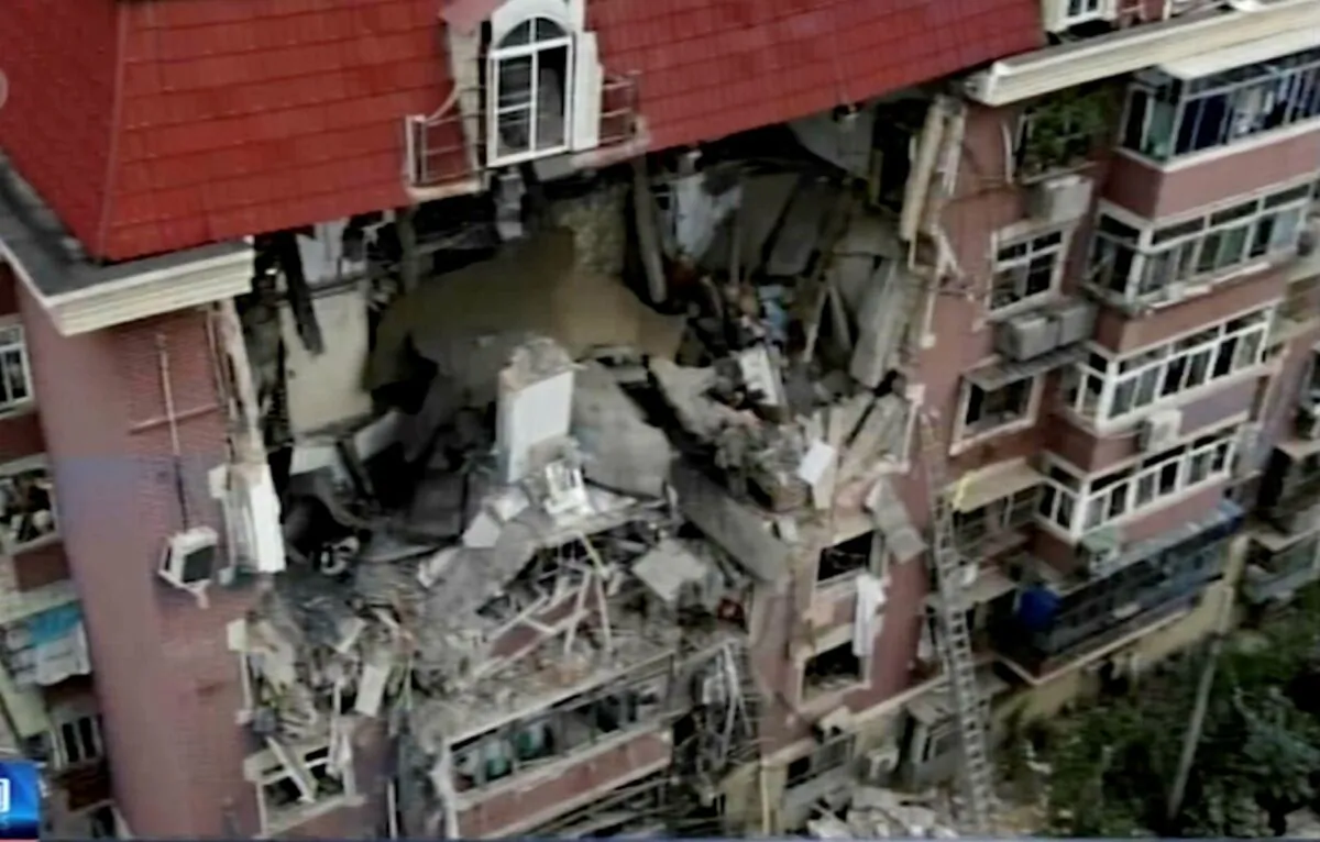 In this image taken from video footage, an aerial shot shows a partially collapsed building in the eastern Chinese port city of Tianjin, China, on July 19, 2022. (CCTV via AP)
