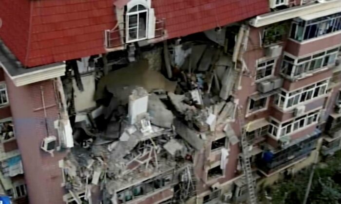 In this image taken from video footage, an aerial shot shows a partially collapsed building in the eastern Chinese port city of Tianjin, China, on July 19, 2022. (CCTV via AP)
