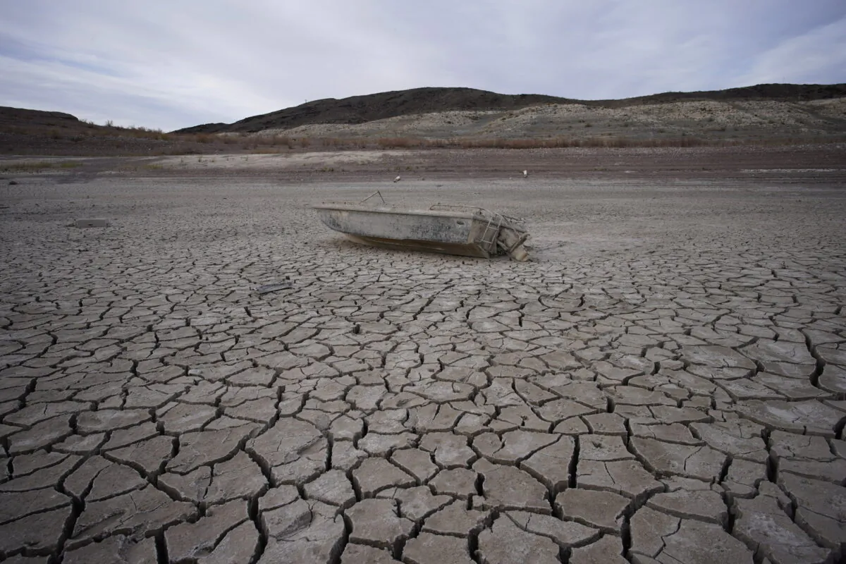 A formerly sunken boat sits on cracked earth hundreds of feet from the shoreline of Lake Mead, at the Lake Mead National Recreation Area, on May 10, 2022, near Boulder City, Nev. (John Locher/AP)
