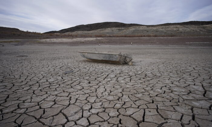 A formerly sunken boat sits on cracked earth hundreds of feet from the shoreline of Lake Mead, at the Lake Mead National Recreation Area, on May 10, 2022, near Boulder City, Nev. (John Locher/AP)