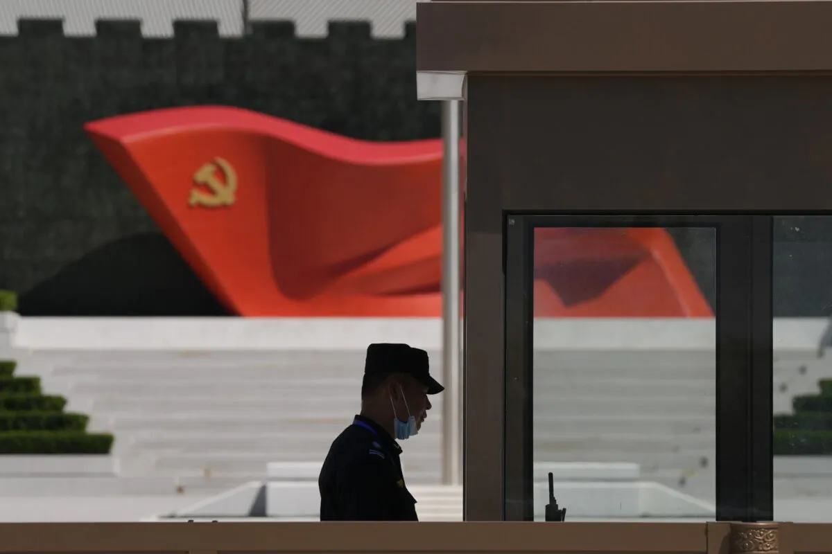 A security guard stands near a sculpture of the Chinese Communist Party flag at the Museum of the Communist Party of China on May 26, 2022, in Beijing.  (Ng Han Guan/AP File)