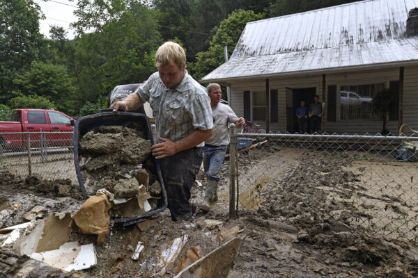 Volunteers from the local mennonite community clean flood damaged