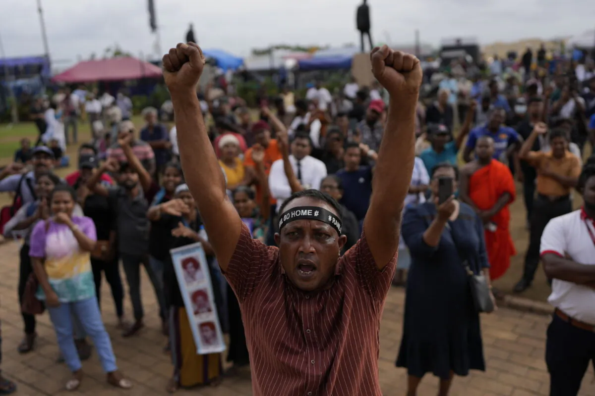 Protesters shout slogans demanding elected president Ranil Wickremesinghe step down during a protest at the presidential secretariat premise in Colombo, Sri Lanka, on July 20, 2022. Sri Lanka's prime minister was elected president Wednesday by lawmakers who opted for a seasoned, veteran leader to lead the country out of economic collapse, despite widespread public opposition. (Rafiq Maqbool/AP Photo)