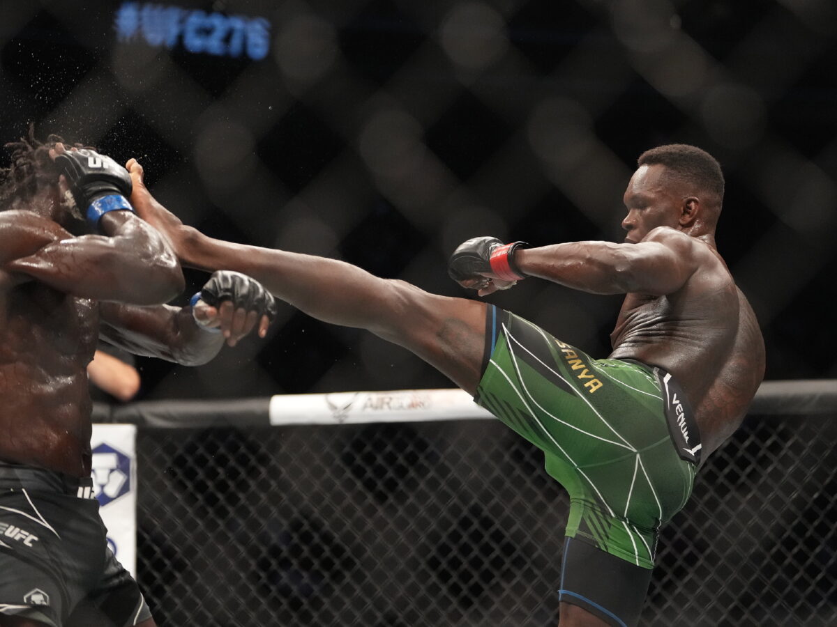 Israel Adesanya (red gloves) and Jared Cannonier (blue gloves), UFC 276