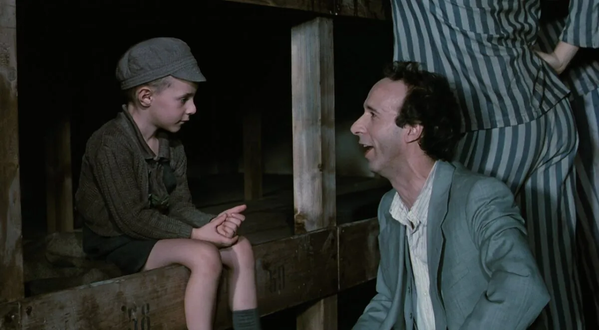 Creating a fable out of the Holocaust is downright dangerous. Giorgio Cantarini as Giosuè (L) and Roberto Benigni as Guido in “Life is Beautiful.” (Melampo Cinematografica) 