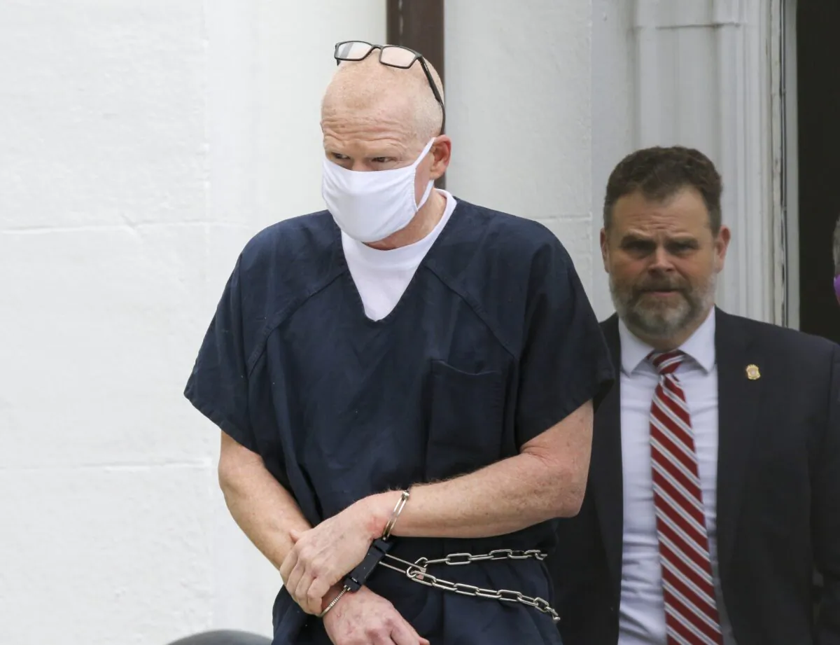Alex Murdaugh is escorted out of the Colleton County Courthouse in Walterboro, S.C., on July 20, 2022. (Tracy Glantz/The State via AP)