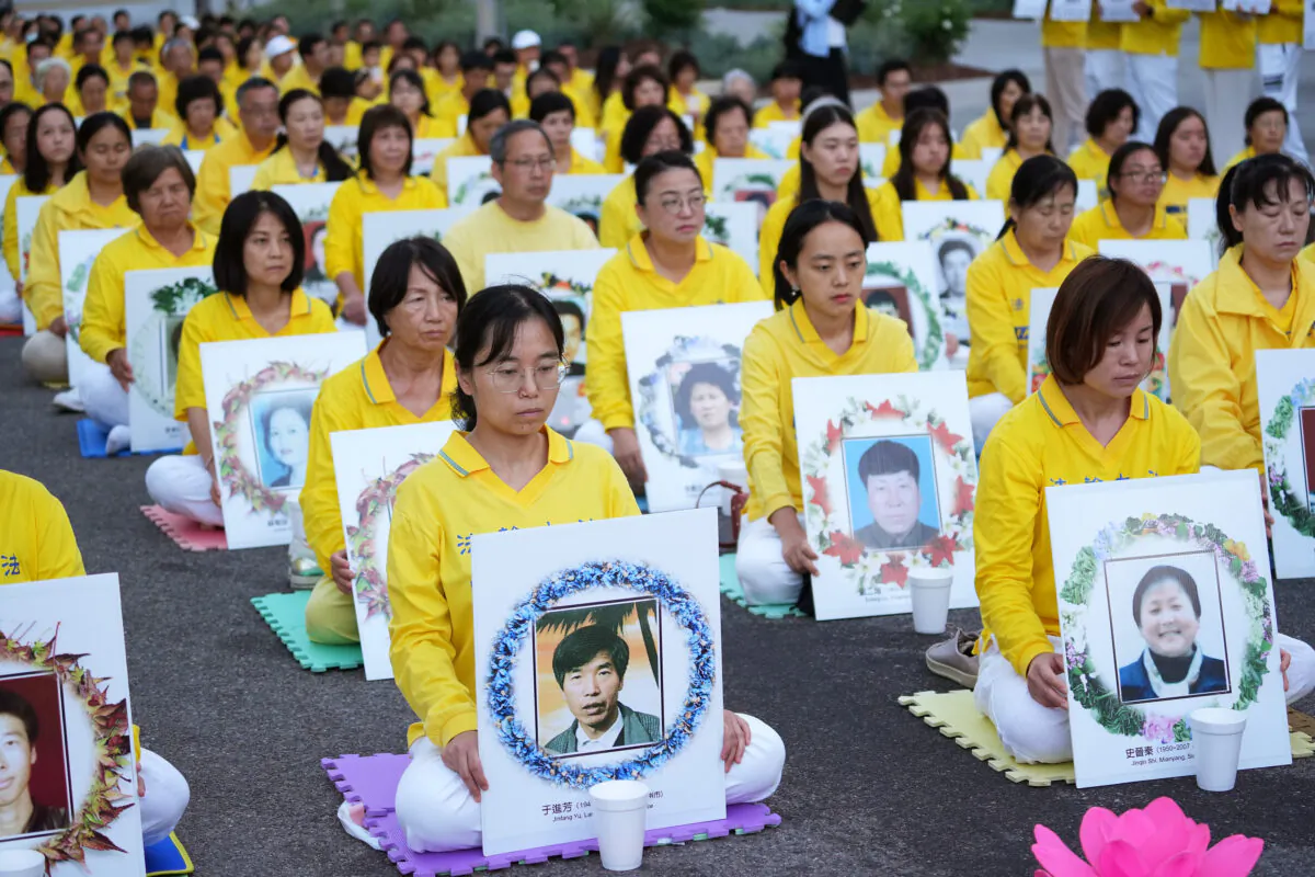 Falun Gong adherents hold a candlelight vigil in front of the Chinese Consulate to mark the 23 years of persecution by the Chinese Communist Party in Los Angeles on July 18, 2022. (Debora Cheng/The Epoch Times)