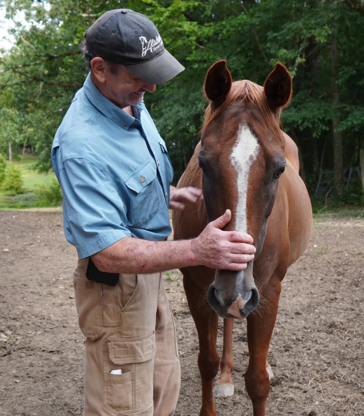 David Dyson with a rescued horse that lives at Compassion Ranch in Jemison, Ala., on July 14, 2022. (Jann Falkenstern/The Epoch Times)