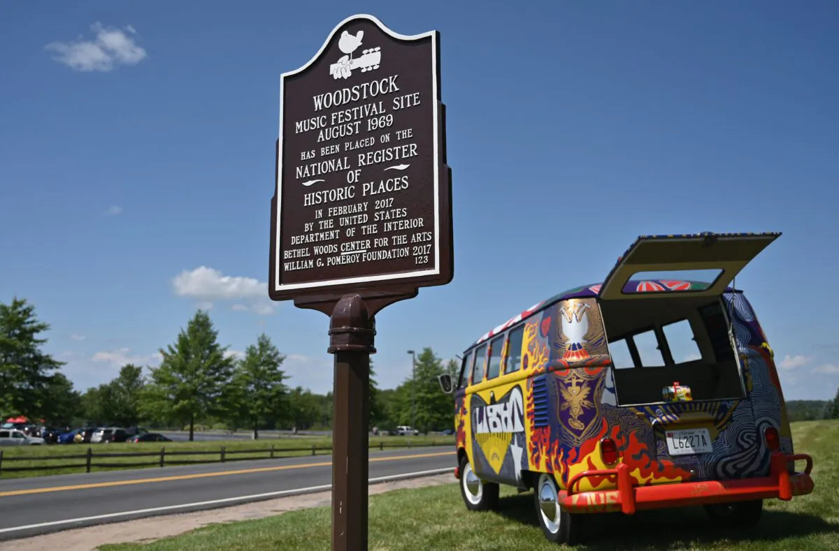 A sign and VW bus is displayed at the Bethel Woods Center for the Arts, Woodstock Music Festival on its 50th anniversary, in Bethel, New York, near Woodstock, on Aug. 15, 2019. (Angela Weiss/AFP via Getty Images)
