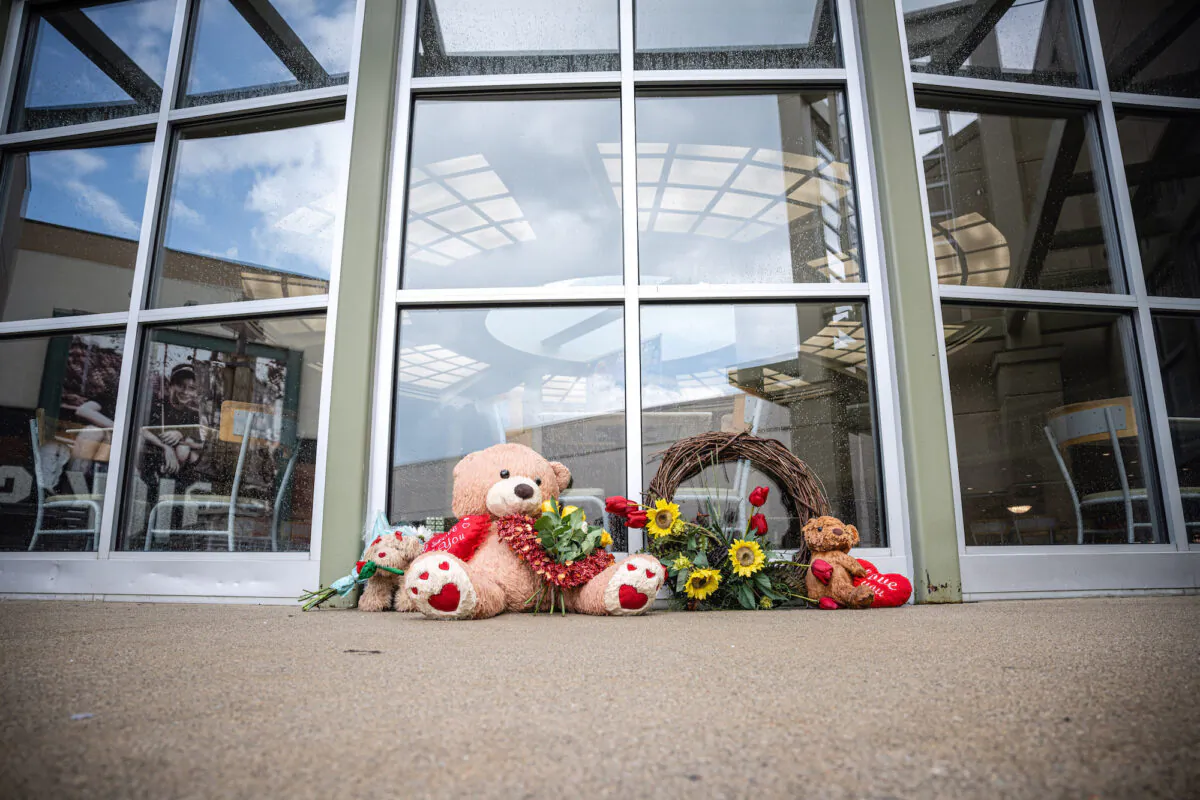 Teddy bears and flowers are sit as a memorial outside of the Greenwood Park Mall food court, in Greenwood, Ind., on July 18, 2022. (Jon Cherry/Getty Images)