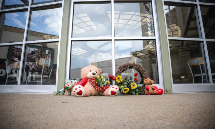 Teddy bears and flowers are sit as a memorial outside of the Greenwood Park Mall food court, in Greenwood, Ind., on July 18, 2022. (Jon Cherry/Getty Images)