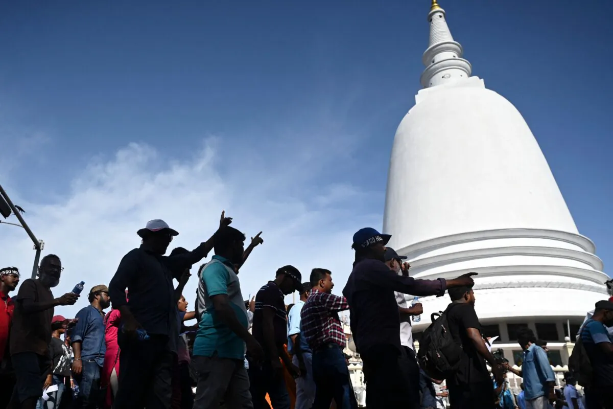 Demonstrators take part in a procession against the interim Sri Lanka's President Ranil Wickremesinghe during a protest in front of the presidential secretariat in Colombo on July 19, 2022. (ARUN SANKAR/AFP via Getty Images)