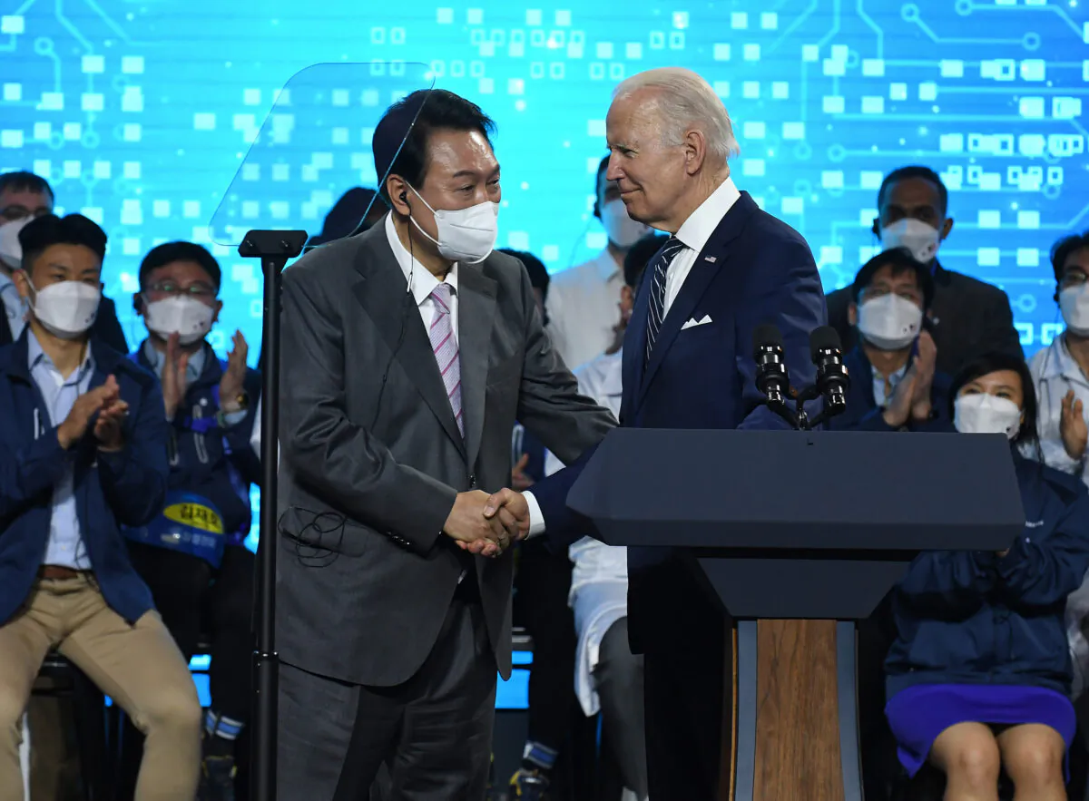 U.S. President Joe Biden shakes hands with South Korean President Yoon Suk-yeol as they visit the Samsung Electronics Pyeongtaek campus on May 20, 2022 in Pyeongtaek, South Korea. (Photo by Kim Min-Hee /Pool /Getty Images)